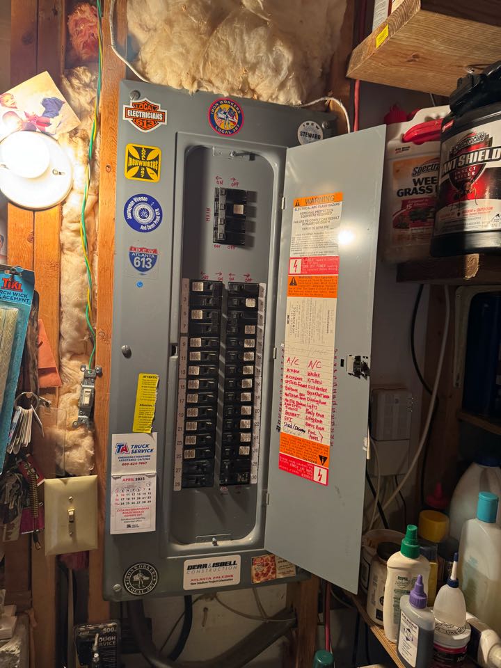 Electrician installing breaker and panel