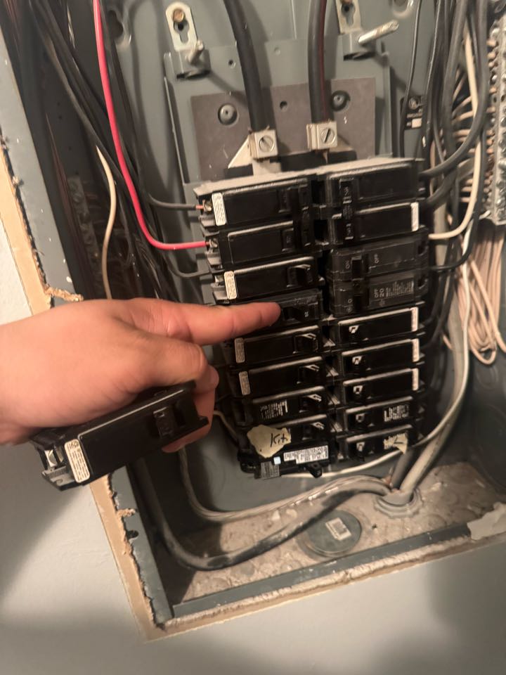 Electrician replacing breaker