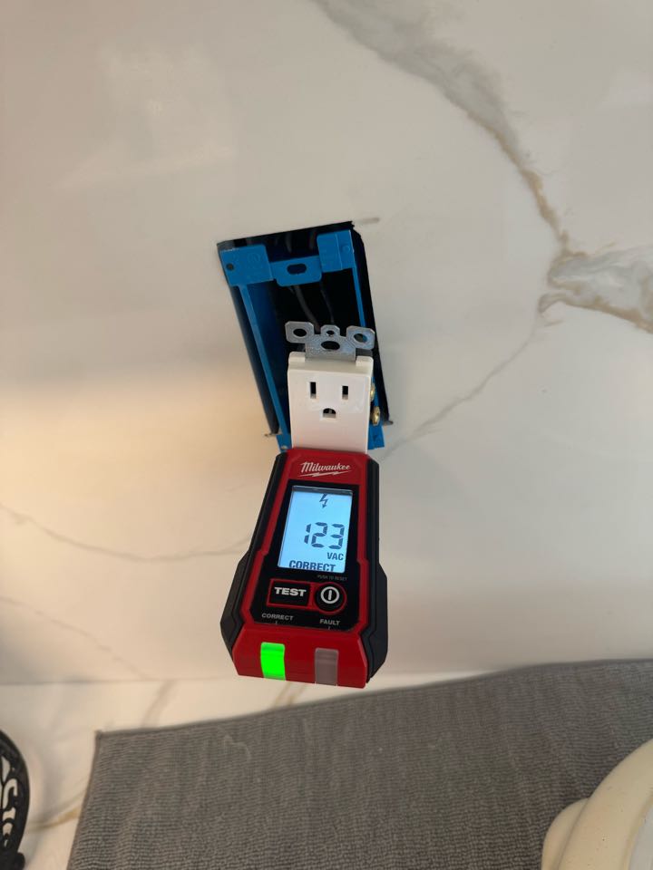 Electrician restoring power to kitchen plug. 