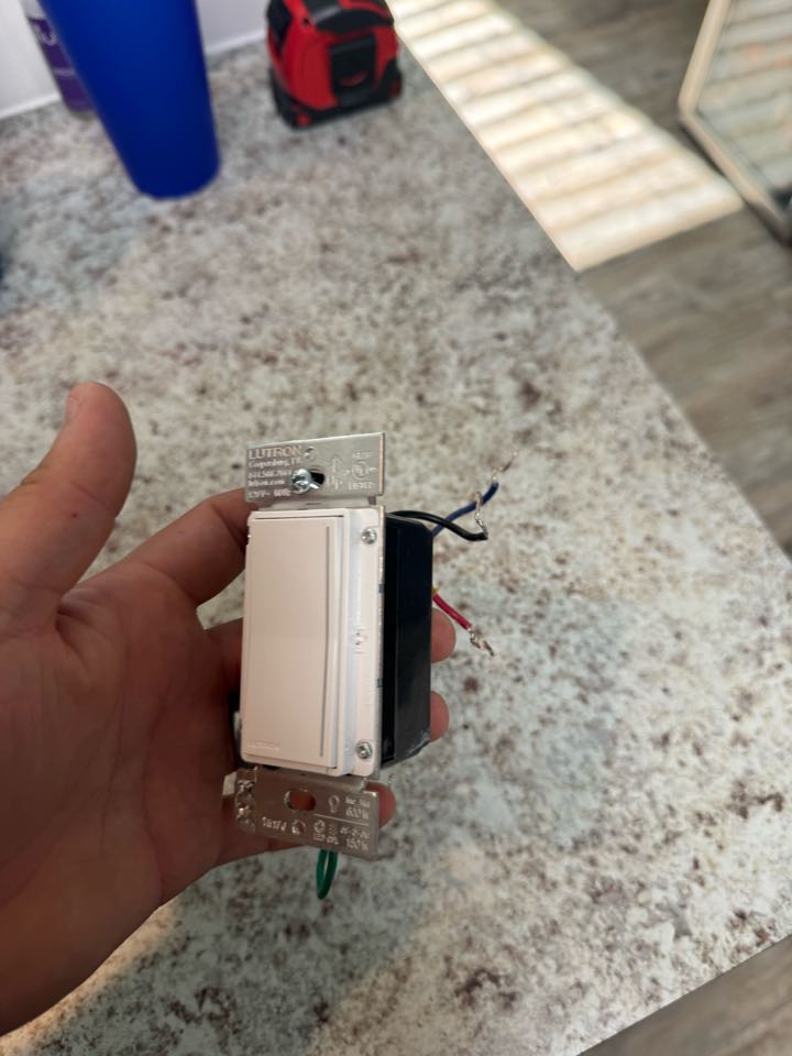 Electrician replacing defective dimmer switch
