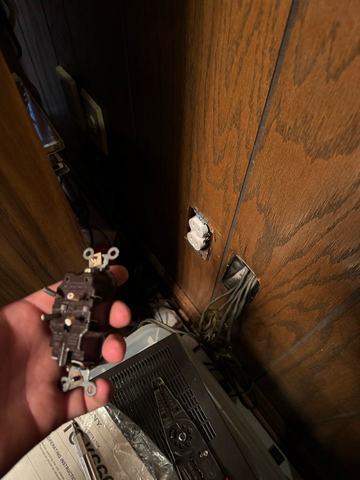 Electrician replacing outlet