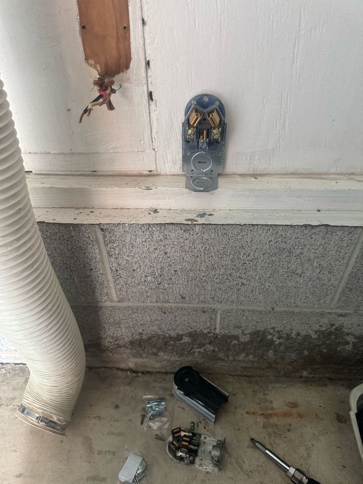 Electrician installing dryer plug. 