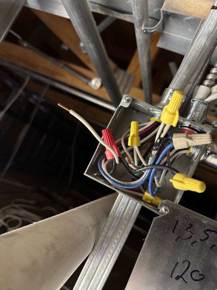 Electrician rewiring junction box. 