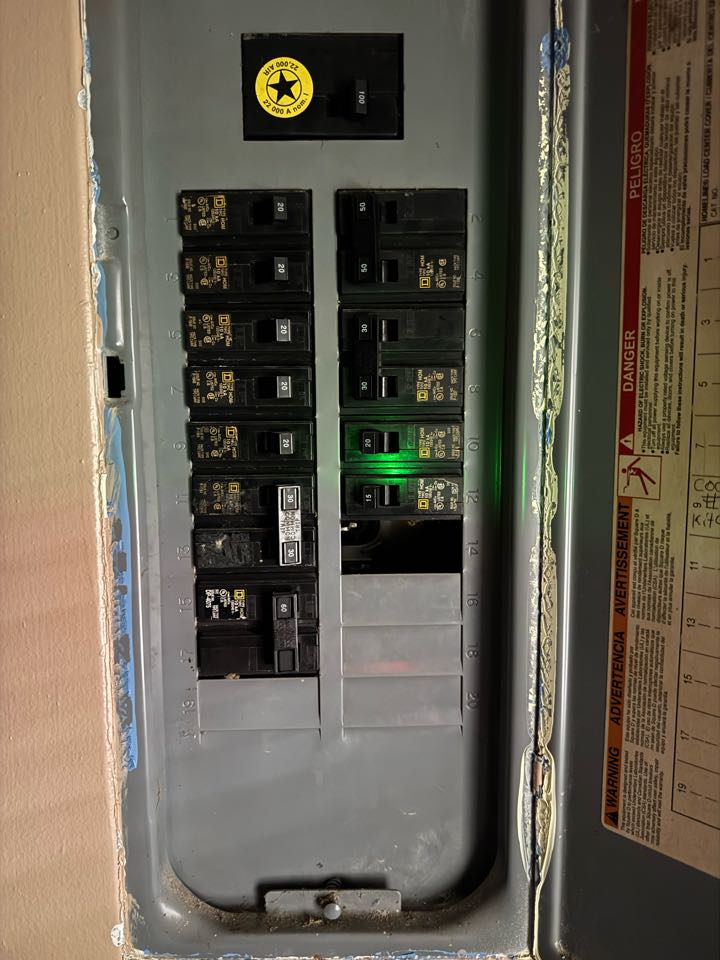 Electrician replacing breaker