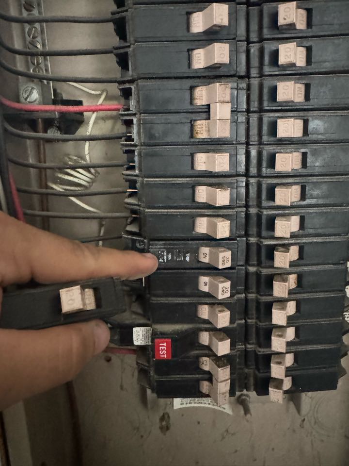 Electrician replacing a breaker