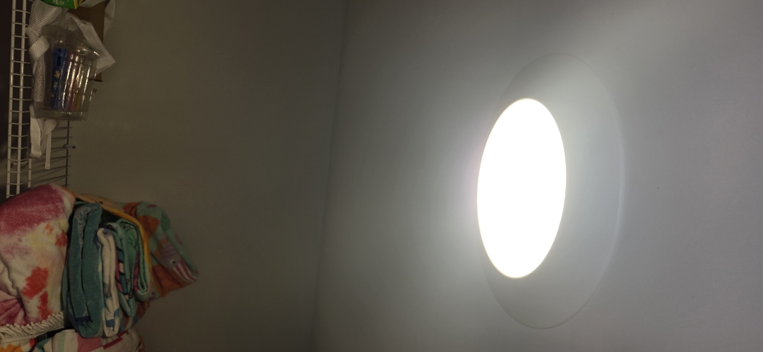 Electrician installing light fixture