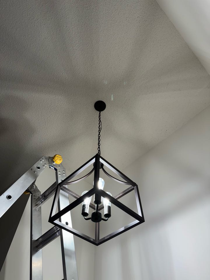 Electrician installing foyer light