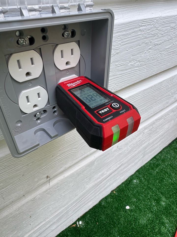 Electrician installing quad outlet on back deck