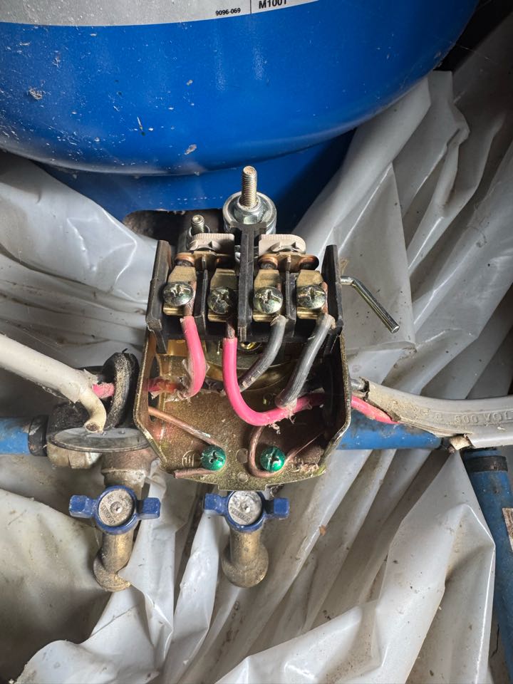 Electrician replacing water pump contacts. 