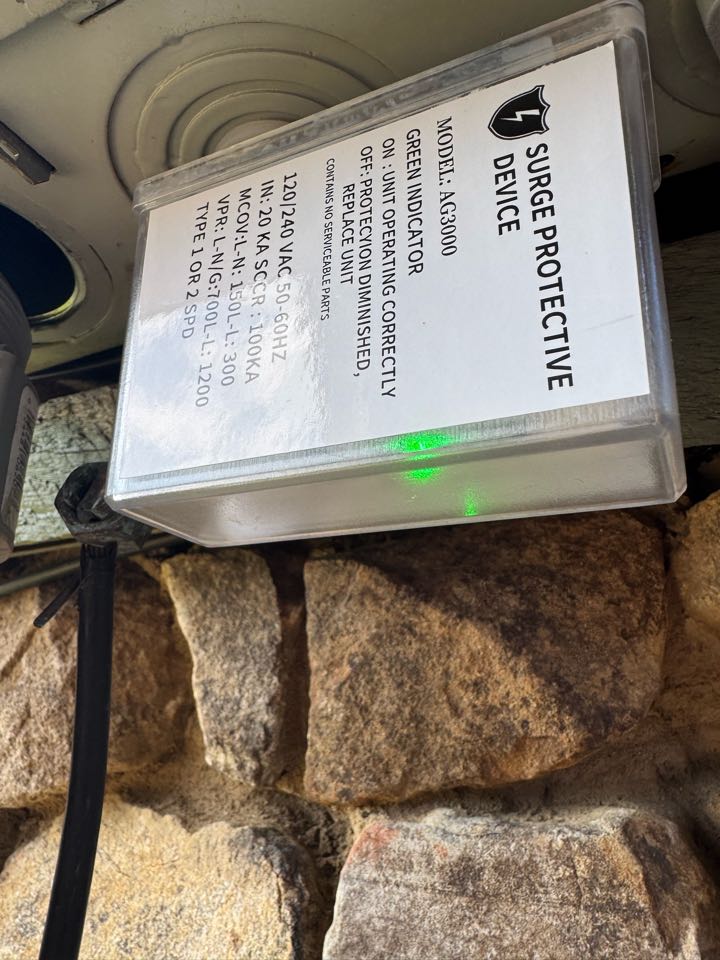 Electrician installing search protectors on disconnect. 
