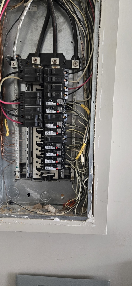 Electrician replacing faulty breaker
