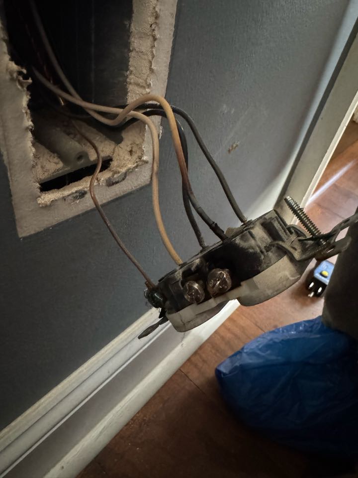 Electrician is replacing a burnt outlets 