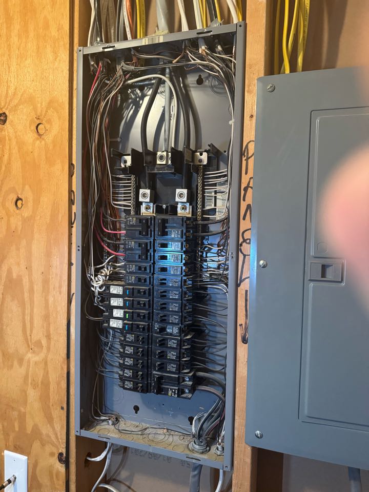 Electrician is performing a panel maintenance. 