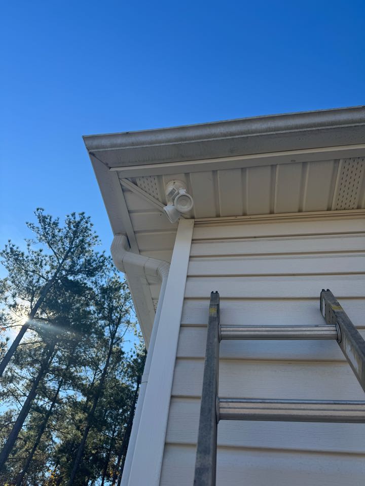 Electrician is installing new flood lights 