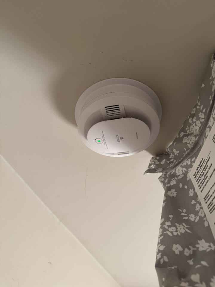 Electrician is installing new smoke detectors 
