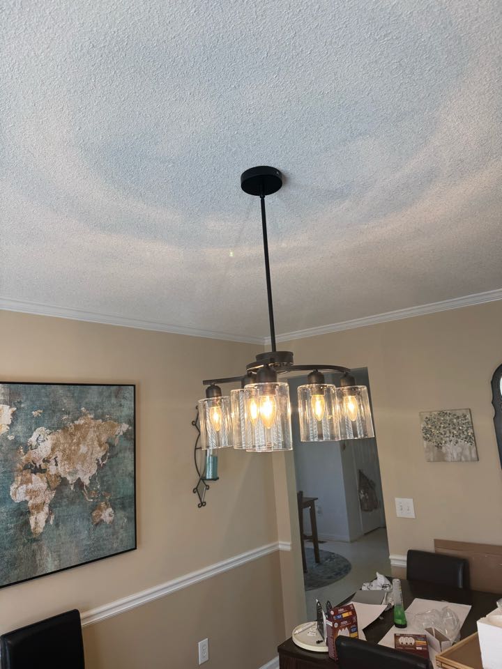 Electrician is replacing light fixtures 