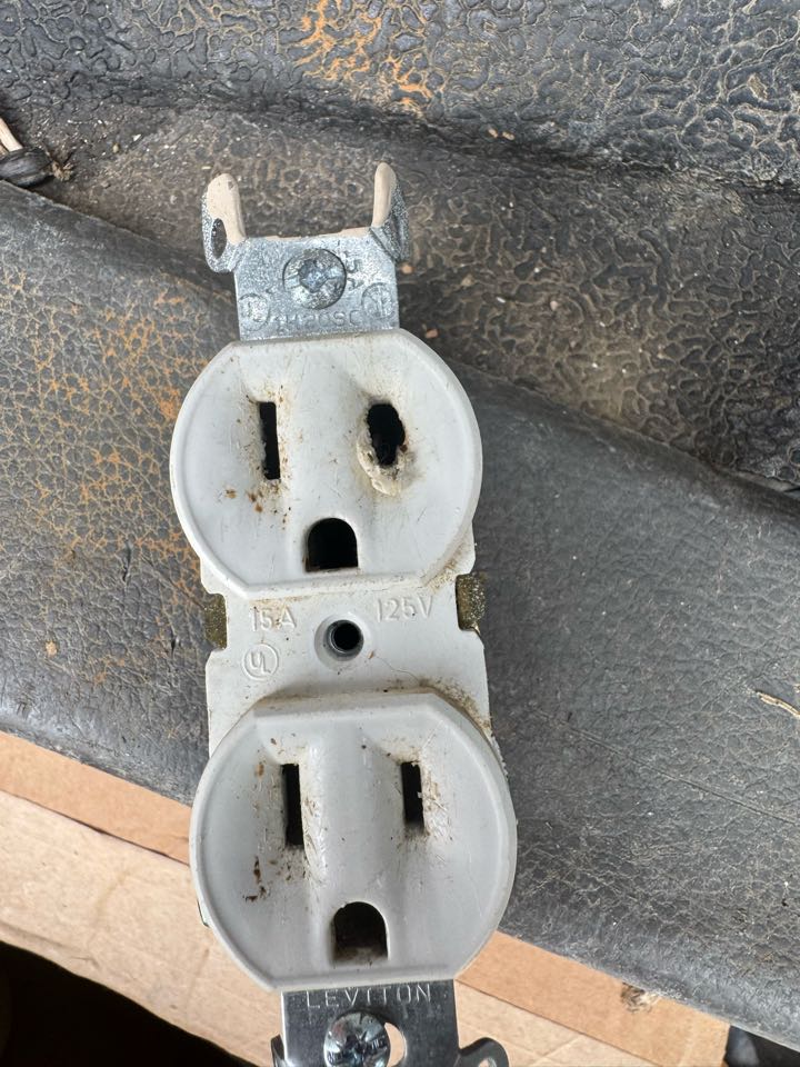 Electrician is replacing a burnt outlet on existing wiring 