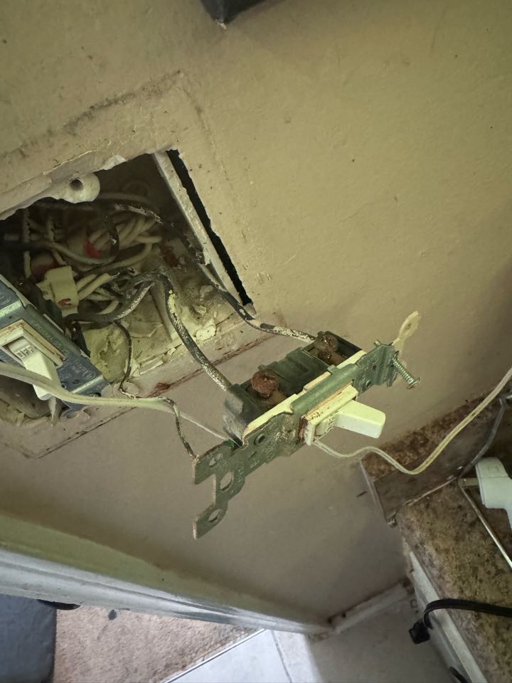 Electrician is replacing old switches 