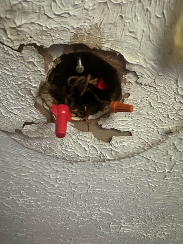 Electrician is repairing old wiring 