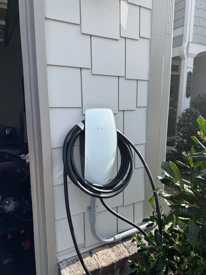 Electrician is installing a new Tesla charger 