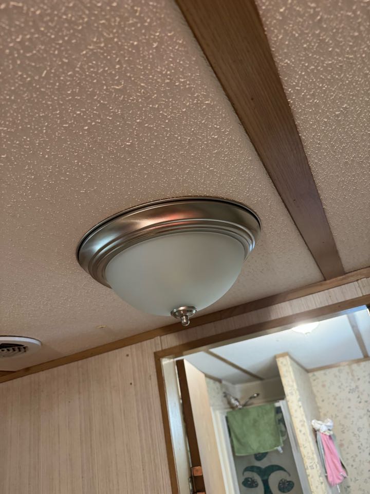 Electrician is installing new light fixtures 