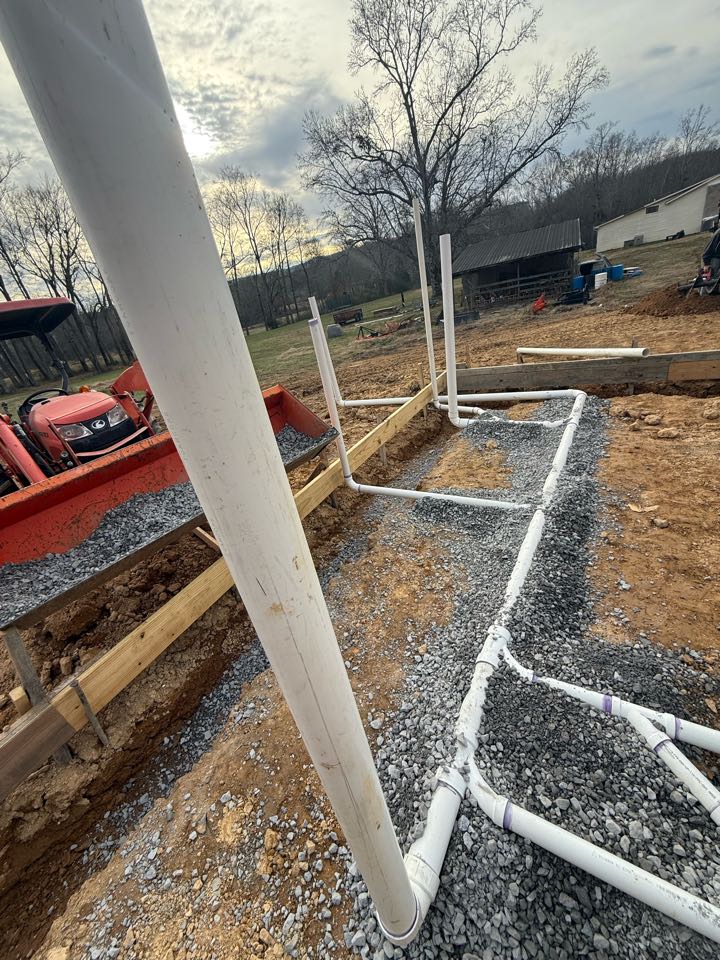 check in for installing underground PVC drain lines for a barn plumbing rough-in