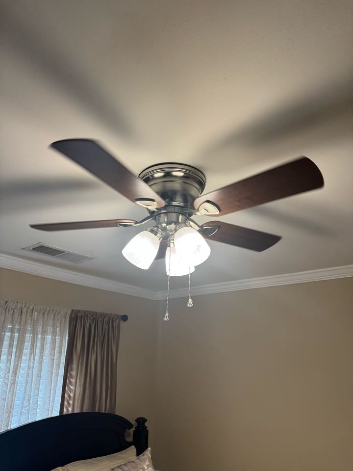 Electrician is installing new ceiling fans 