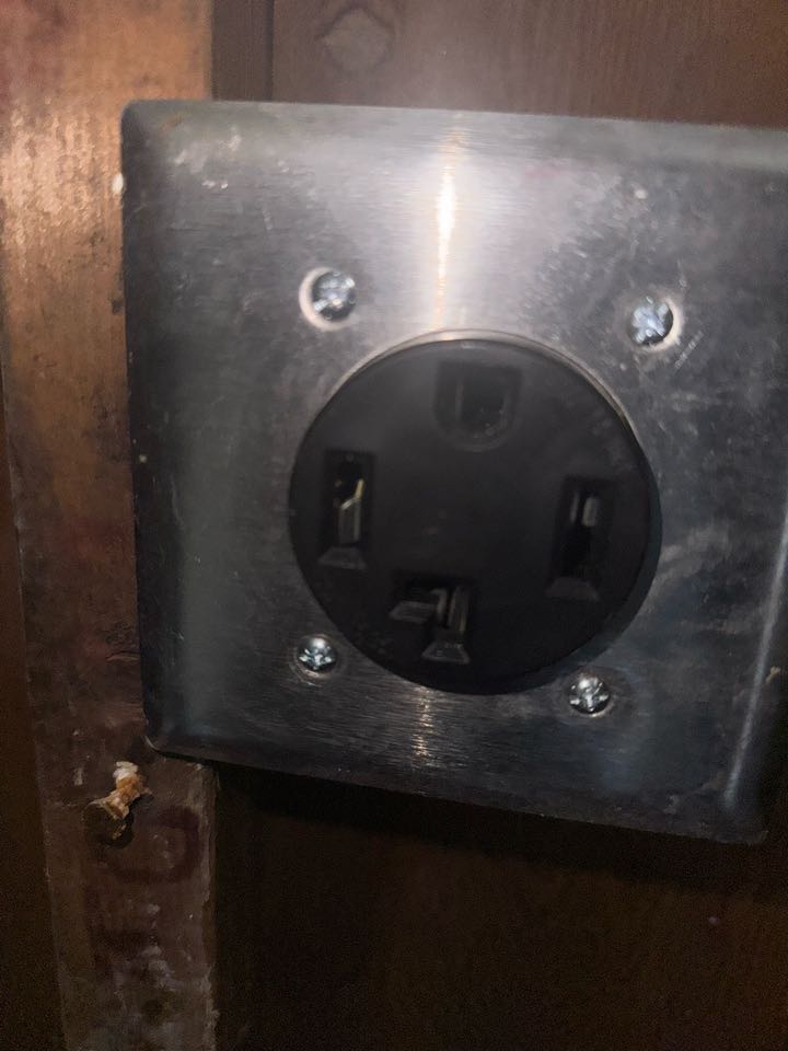 Electrician is repairing a dryer outlet 