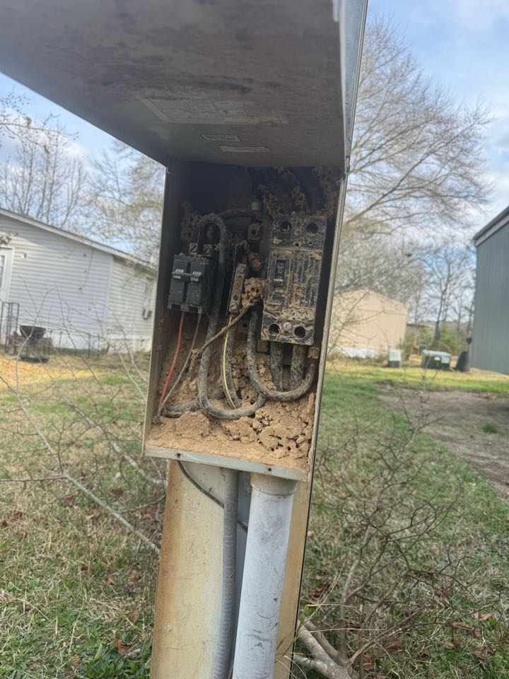 Electrician is replacing a meter service 