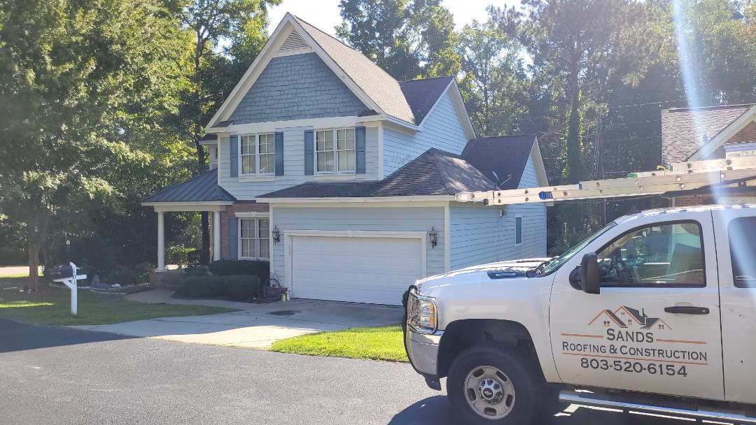 Residential shingle roof leak due to storm damage.