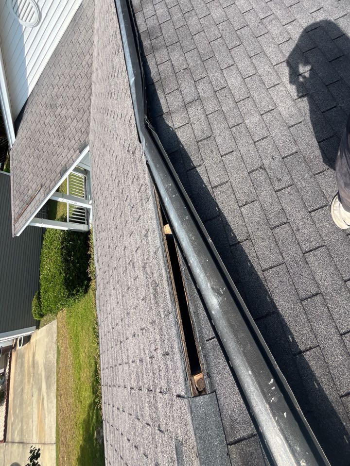 We are quoting a fix for this metal ridge vent and all existing shingles on the roof that have either been damaged or blown off. 