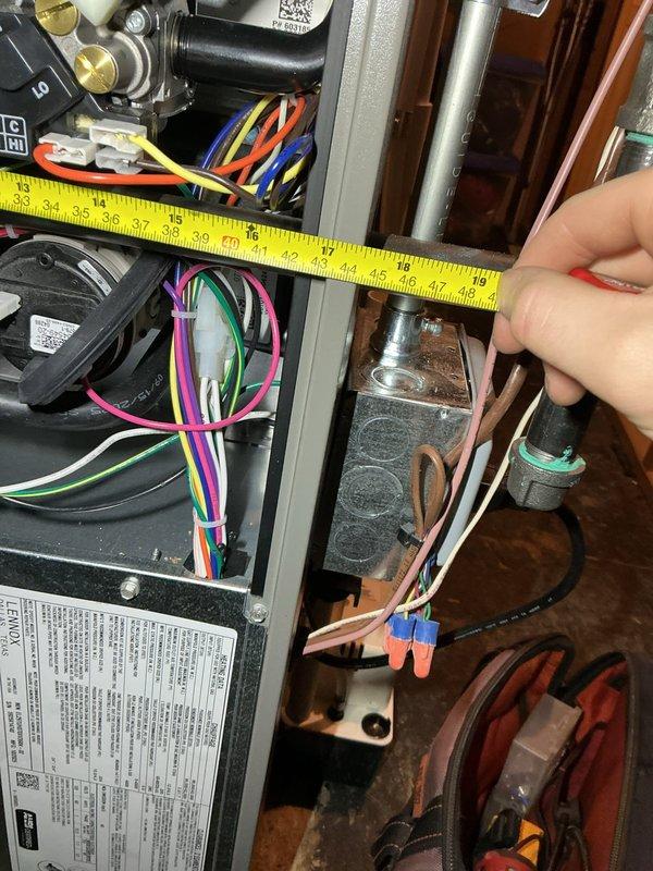 Responded to call back regarding furnace making loud humming noise. Conducted inspection and measurements of electrical components including motor/fan assembly and associated wiring connections. Checked PVC pipe placement and clearances, and verified proper installation specifications of recently installed 70,000 BTU furnace with humidifier.