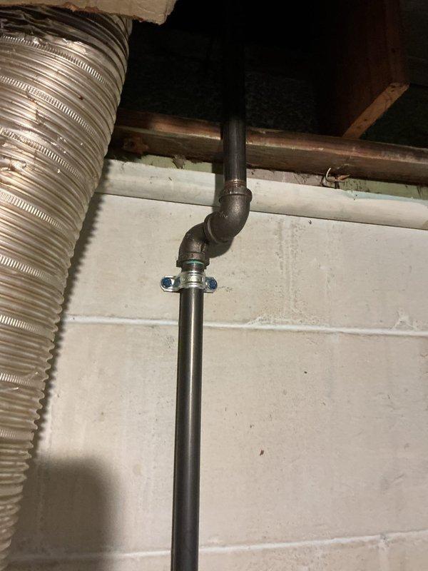 Responded to service call for gas leak at dryer location previously shut off by DTE. Performed visual inspection of the gas line system in utility area, focusing on the vertical black pipe with red valve handle and associated connections. Conducted pressure testing to verify integrity of remaining gas supply infrastructure and confirm isolation of the compromised section.