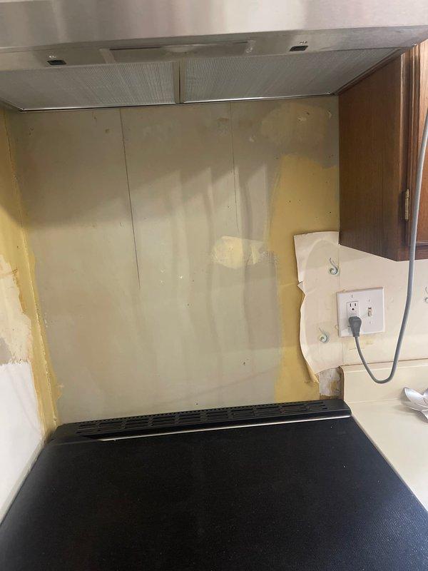 Installed new electrical outlet above kitchen cabinet to power customer's range hood vent. Accessed interior cabinet wiring, ensuring proper connection while maintaining code compliance during the kitchen renovation process.