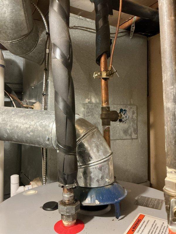 Performed comprehensive tune-up on 10-year-old HVAC system located in basement. Inspected humidifier, thermostat, and hot water tank per standard protocol. Identified significant moisture damage on concrete wall adjacent to ductwork, likely indicating condensation issues or possible leak at connection point requiring attention.