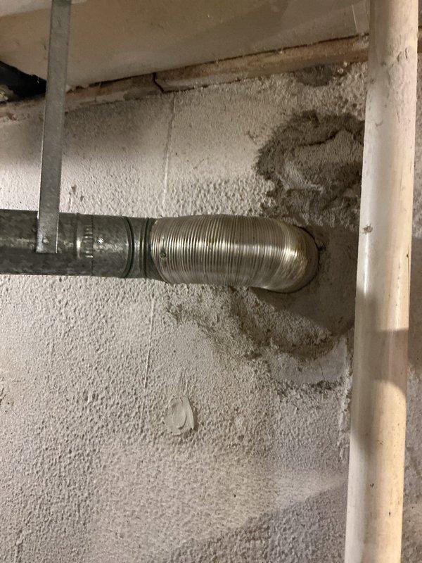 Performed comprehensive tune-up on 10-year-old HVAC system located in basement. Inspected humidifier, thermostat, and hot water tank per standard protocol. Identified significant moisture damage on concrete wall adjacent to ductwork, likely indicating condensation issues or possible leak at connection point requiring attention.