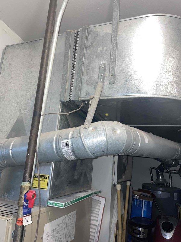 Conducted inspection of 27-year-old counterflow HVAC system. Furnace exhibited fracture formation with dark rust spot, oil leakage from blower motor, and inducer motor operating at maximum rated amperage. AC system uses R22 refrigerant with documented low charge from previous service. Recommended complete system replacement due to advanced age, deteriorating conditions, and compatibility requirements of counterflow configuration.