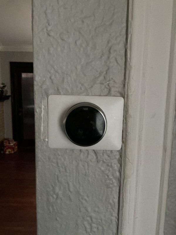 Conducted comprehensive inspection on 30-year-old steam boiler system (1989 model) located in basement. Identified unit as completely sooted up requiring service. Inspection included evaluation of associated components including Nest thermostat, humidifier, and hot water tank. Documentation of plumbing infrastructure and control systems completed with photographic evidence.