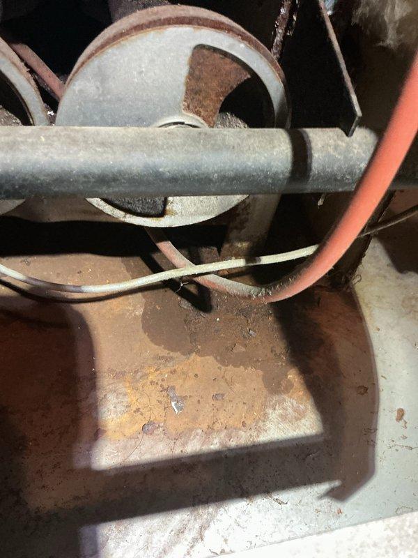 Diagnosed non-functional boiler that had previously experienced intermittent operation. Inspection revealed severe corrosion on critical piping components and damaged electrical connections, with significant rust accumulation on the pulley/belt assembly. Replaced deteriorated components, restored proper electrical connections, and successfully restored system operation.