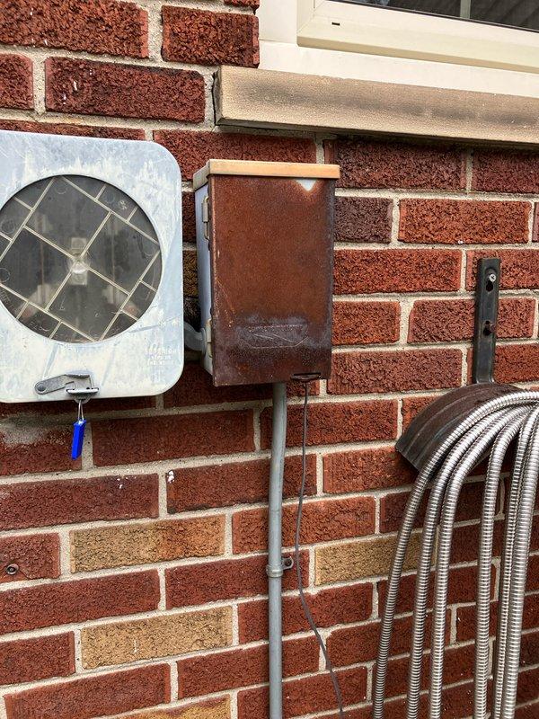 Conducted a comprehensive evaluation for full HVAC system replacement, including assessment of the existing outdoor unit showing significant weathering and oxidation on component enclosures. Inspected the current Ritetemp digital thermostat (displaying 70.5°F) and discussed potential rebate opportunities for the new system installation.