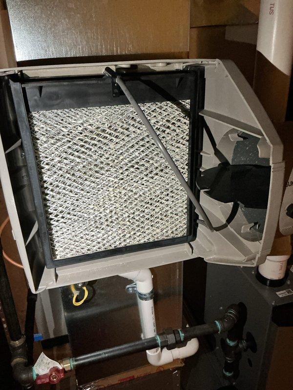 Conducted IAQ assessment on Bryant HVAC system installed in basement 5 months ago (under warranty) in response to customer complaint of "crammy" feeling and possible excess humidity. Inspected filter condition and system components, confirming proper installation of ductwork, copper lines, and control panel. Verified seasonal settings were properly configured for optimal indoor air quality.