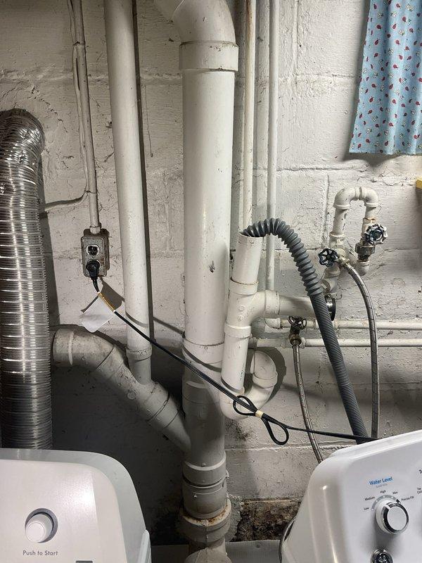Responded to callback regarding water leak from PVC pipe behind washing machine after previous repair. Inspected utility area and found disconnected PVC drain pipe causing water to spew out. Reconnected and secured the pipe connection, then verified proper drainage and tested hot water functionality which was restored to normal operation.