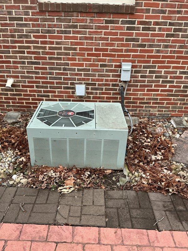 Conducted an estimate for replacement options on a 1999 HVAC system with multiple failures including seized blower motor and grinding inducer motor resulting in no heat. Presented customer with replacement options for furnace-only and complete furnace/AC system configurations, with additional humidifier installation options for both scenarios. System is located in basement of brick residential structure with existing outdoor condenser unit positioned on concrete pad against exterior wall.