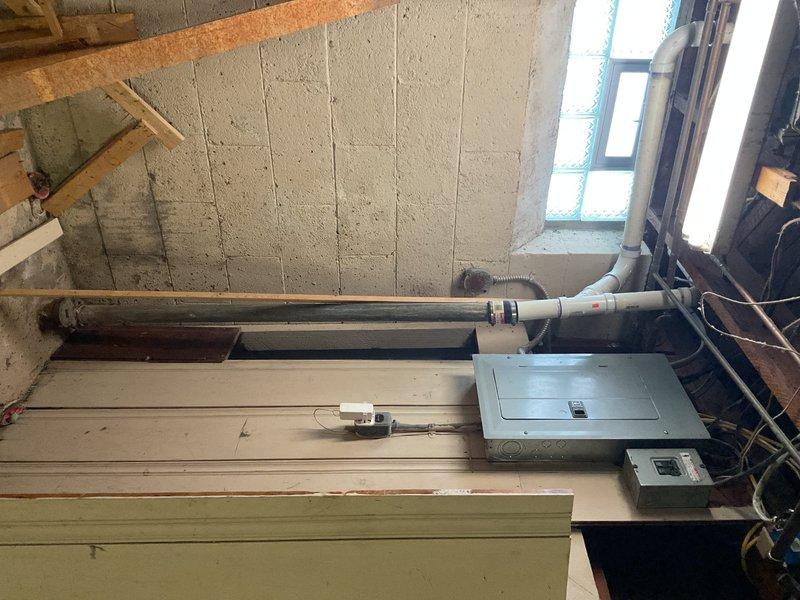 Inspected copper piping under sink for reported leak. Examined P-trap configuration and PVC connections which showed signs of wear. Identified and repaired leak at connection point between drain flange and wall. Verified proper drainage function and confirmed no further water leakage from the plumbing system.