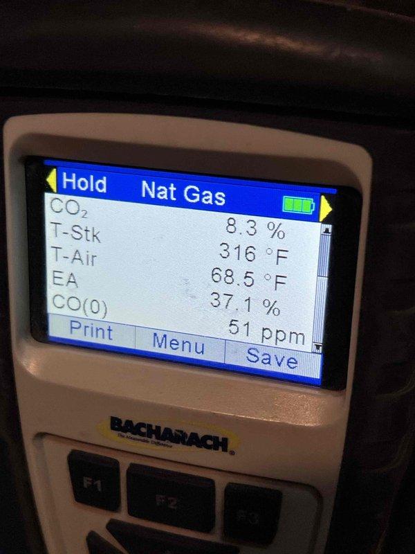 Completed Gold Boiler Inspection on steam heating system under 10 years old. Conducted combustion analysis using Bacharach analyzer, recording stack temperature of 316°F, CO2 at 8.3%, excess air at 37.1%, and CO levels at 51 ppm. System is operating within acceptable parameters with no immediate concerns identified.