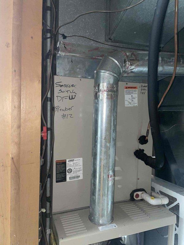 Conducted full system replacement estimate for aging HVAC unit with non-functioning blower. Inspection revealed existing Lennox system installed in utility area with proper ductwork connections, service switch labeled "DFCU Feeder #12," and standard condensate drainage setup. Documented current installation configuration including electrical connections and mounting platform to ensure appropriate replacement specifications.