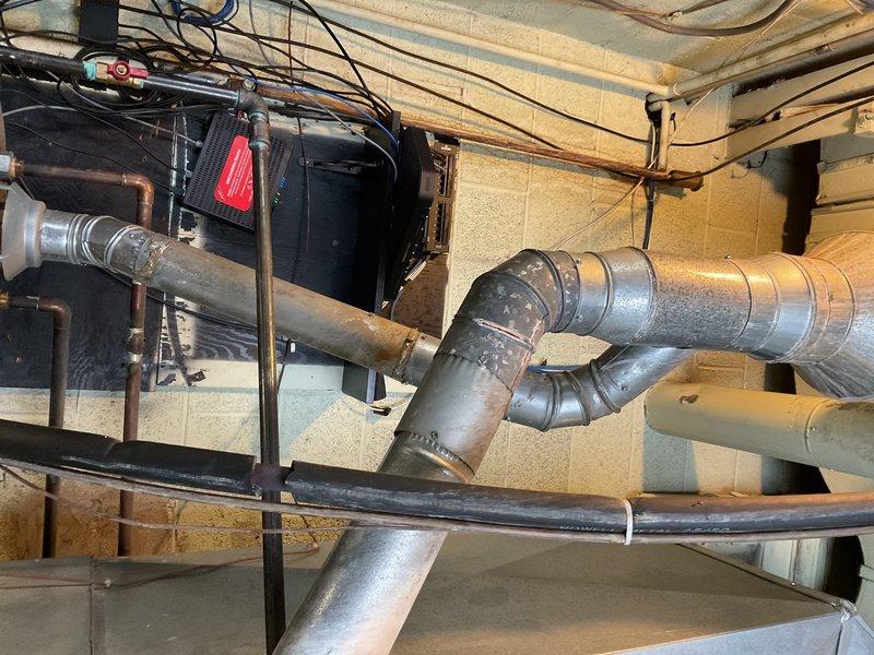 Responded to service call for non-functioning Rheem Performance commercial water heater (approximately 12 years old) located in boiler room. Upon inspection, identified ignition failure in the tank system. Performed diagnostic assessment, documented condition with photos of the installation including ductwork, venting, and copper pipe connections.