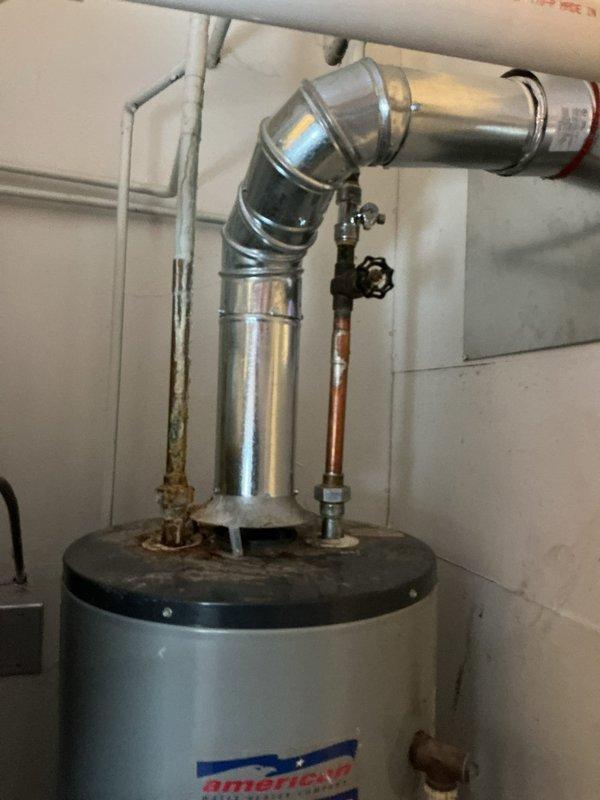 Responded to service call for American ProLine tanked water heater with reported hot water outage and tank leakage. Inspected unit and identified corrosion at pipe connection point on top of heater, which was causing water leakage. Replaced damaged fittings, verified proper venting through galvanized exhaust pipe, and restored hot water functionality to residence.