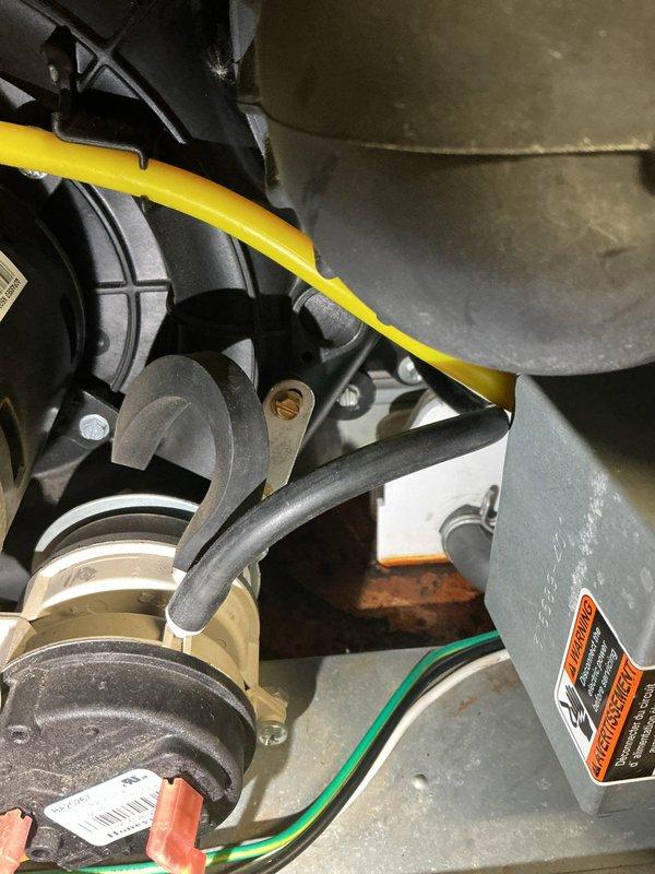 Responded to a service call for rusty water leaking from underneath an 11-year-old furnace in customer's basement. Determined the issue was related to the condensate trap, which had previously failed under warranty. Inspected internal components, documented corrosion, and replaced the defective condensate assembly to resolve the water leak while confirming proper system operation.