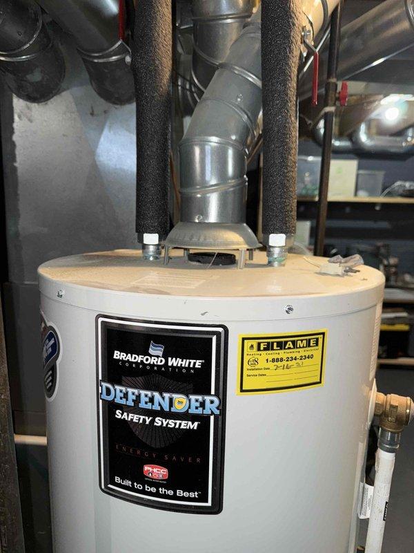 Conducted Gold Furnace Inspection on 19-year-old forced air system located in basement. Inspected electrical wiring and connections in control panel, noting bundle condition and proper color coding. Examined adjacent Bradford White water heater with Defender Safety System, verifying proper ductwork connections and exhaust ventilation.